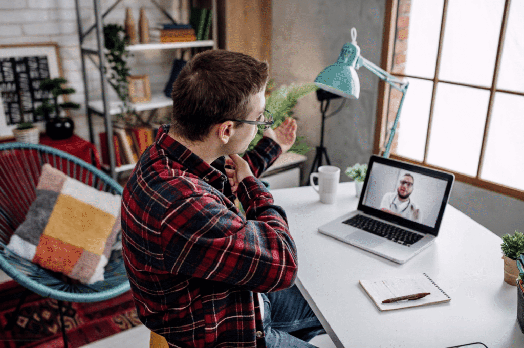 A man is having a virtual appointment with his doctor, and his schedule is not disrupted.