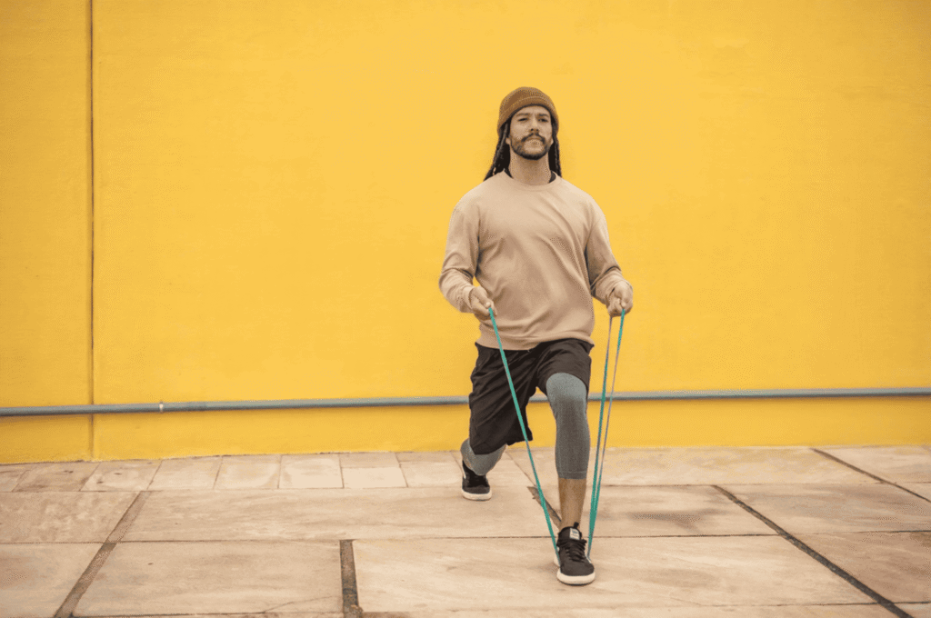 A man is pulling a taut resistance band.