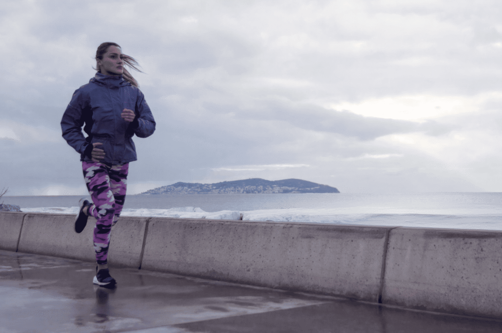 A woman is running outdoors for high-intensity interval training.