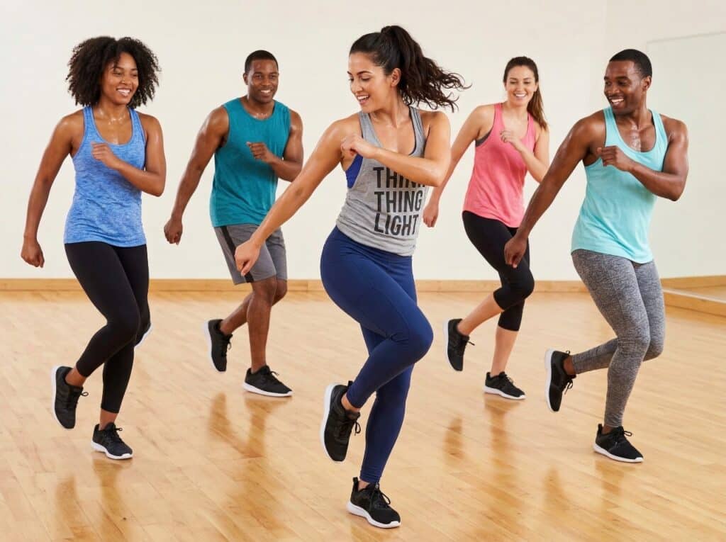 An energetic group performing rapid Latin dance moves in the studio.