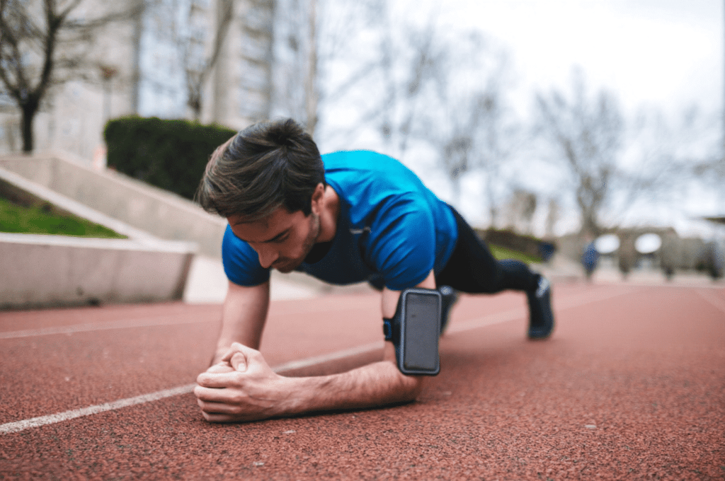 A man is doing planks as isometric exercises to lose weight.