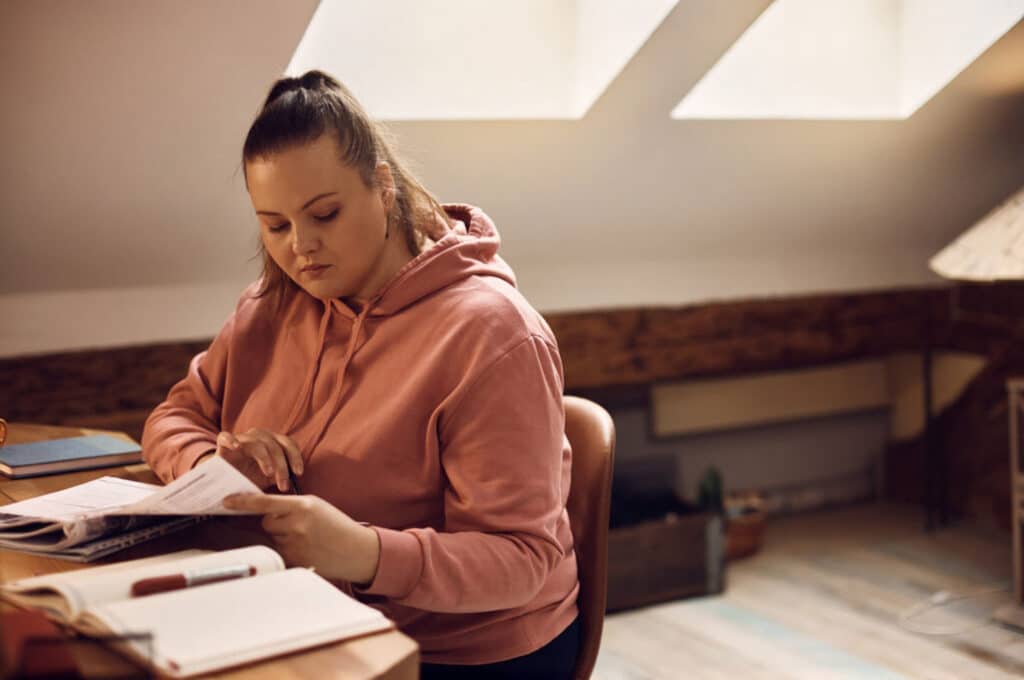 A woman is preparing her medical records to bring to her first weight loss consultation.