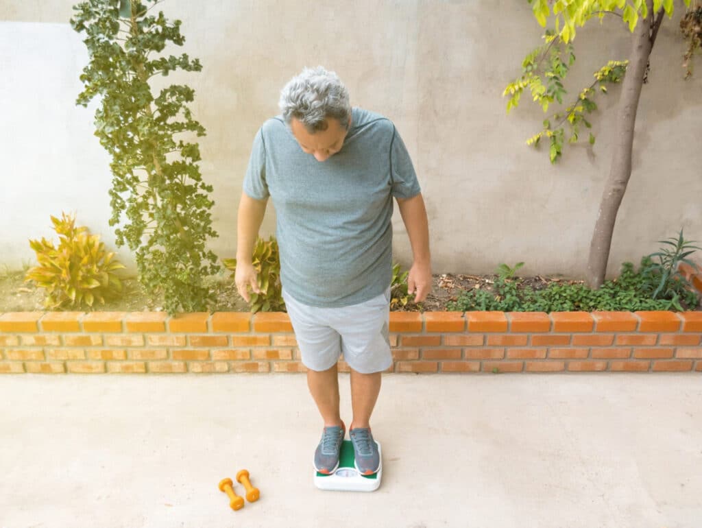 A man finds it difficult to lose weight despite exercising regularly.