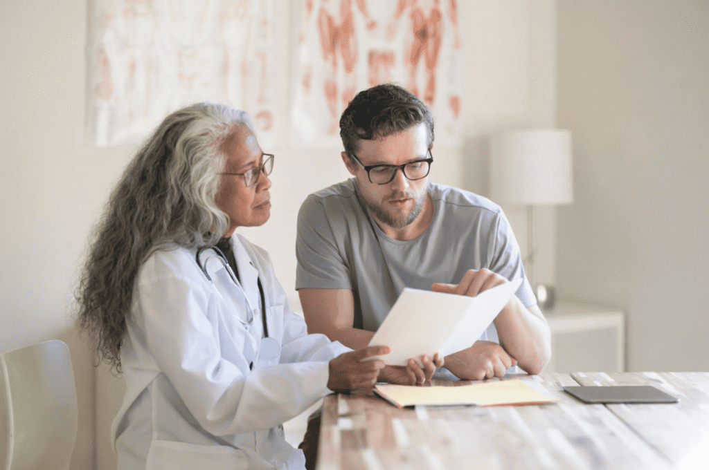 A man is inquiring with a clinician about included follow-up care.